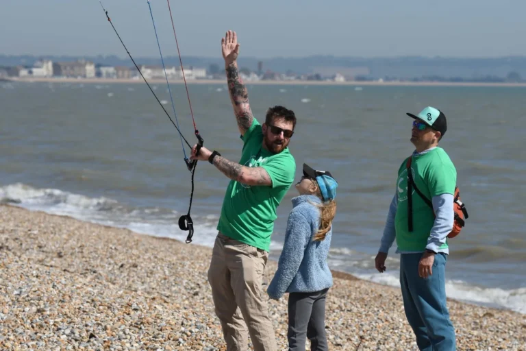 Instructor coaching a young rider with a trainer kite at Kids Day